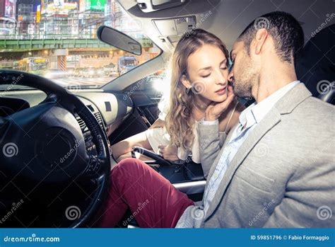 couple kissing in car